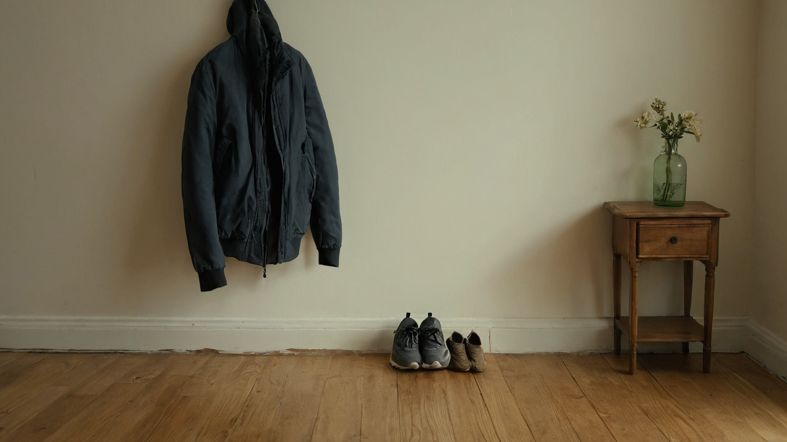 A jacket and walking shoes staged near a home entryway
